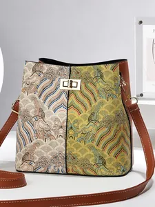 Oriental embroidered bucket bag with traditional pattern and brown leather trim details