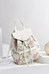 Detail view of floral print backpack with metal buckle and drawstring closure