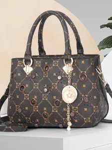 Women's dark brown printed handbag with floral cutouts and gold star moon charm