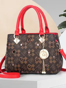 Brown and red textured crossbody handbag with star pendant and vintage monogram print