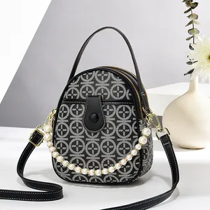 Chic black and white geometric pattern oval handbag with pearl chain and leather strap