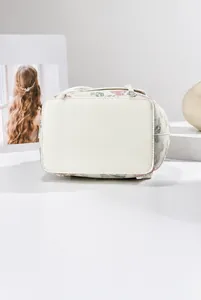 Detailed view of the reinforced bottom and floral print side of the white travel backpack