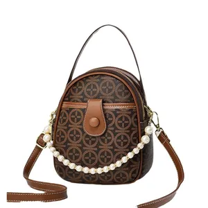 Retro brown printed round crossbody bag with leather trim and pearl chain charm accessory