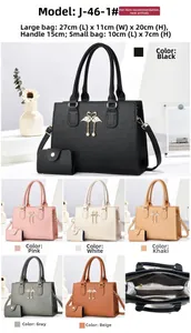 Detailed view of women's tote set with swan emblem and small wallet dimensions