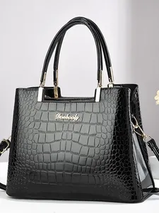 Bolso de mano negro para mujer con relieve de cocodrilo y logotipo dorado