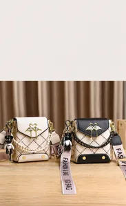Detail of color-block crossbody bag with golden swan clasp and pearl chain strap