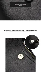 Détail d'un sac à main noir en cuir grainé avec boucle magnétique et fermeture éclair