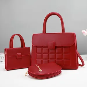 Three-piece red pebbled leather bag set including large tote and stylish handbags