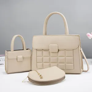 Three-piece set of beige lychee texture handbags including tote and crossbody styles