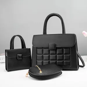 Detailed close-up of a 3-piece black pebble leather handbag set with quilted texture