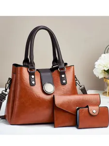 Three-piece set of caramel brown faux leather tote bags with elegant silver buckle detail