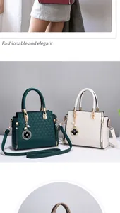 Detail of quilted leather handbag with gold hardware and pearl clover charm accessory