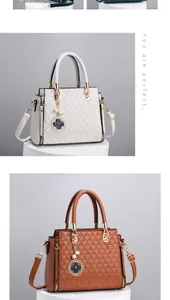 Detail of embossed geometric patterns and pearl clover charm on tote bags