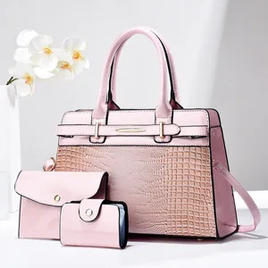 Detailed view of pink 3-piece bag set with shiny patent leather and crocodile texture