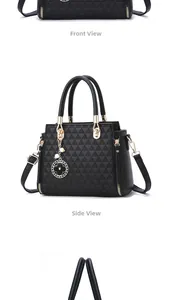 Detail view of black tote bag with triangle embossed texture and pearl clover charm