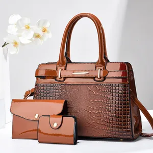 Detailed view of brown 3-piece tote set with glossy patent leather and croc texture