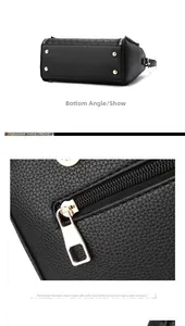 Detail of black pebbled leather tote showing metal base studs and gold hardware zipper