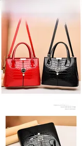 Detail of glossy stone pattern handbags with adjustable straps and cat charm