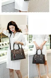 Detail of coffee brown quilted handbag with gold hardware and elegant tassel charm