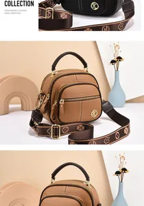 Detail of lychee pattern leather handbag with wide jacquard strap and gold K logo