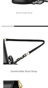 Dettaglio della borsa a sella in pelle nera con finiture dorate e tracolla in foulard