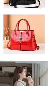 Detailed macro of glossy crocodile embossed leather handbag with chic metal cat charm