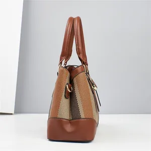 Close-up side view of woven texture and premium brown leather on a women's tote bag
