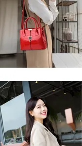 Macro view of a red crocodile pattern leather handbag with gold cat-shaped metal charm