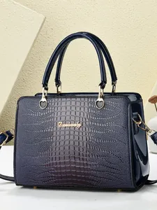 Navy blue crocodile pattern tote bag with glossy finish and gold heart hardware
