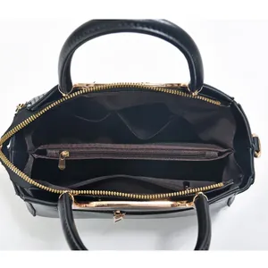 Top view of spacious handbag interior with gold zippers and multi-compartment storage