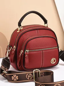 Red lychee pattern crossbody bag with wide clover strap and triple zipper structure
