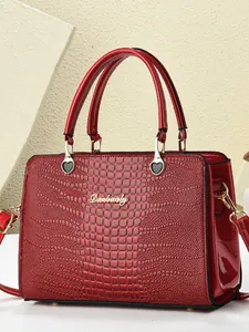 Polished bright red crocodile pattern tote bag with gold hardware and top handle strap