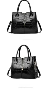 Front and side view of black crocodile pattern patent leather tote bag with cat pendant