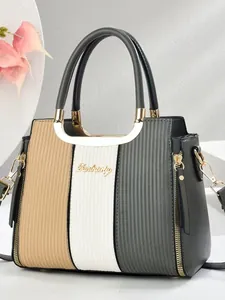 Three-color patchwork faux leather handbag with gold hardware and elegant vertical stripes