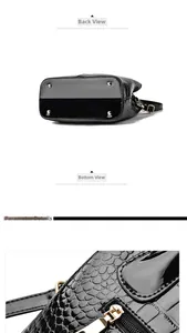 Detailed view of crocodile pattern leather handbag bottom with gold metal studs