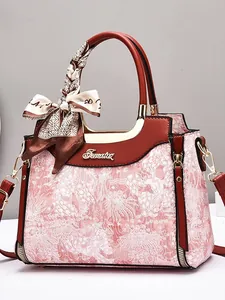 Elegant floral jacquard handbag with brown leather trim and decorative scarf