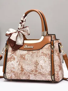 Elegant vintage handbag with embossed texture, silk scarf handle, and golden hardware