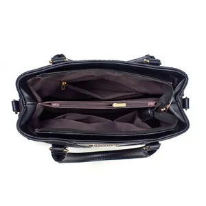 Top view of large black tote bag interior showing multiple compartments and gold zippers