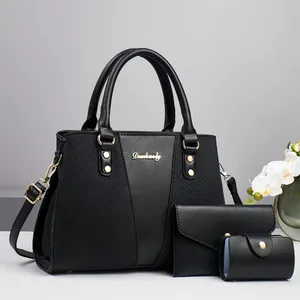 Three-piece black tote bag set including large shoulder bag, wallet and small pouch
