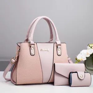 Detail view of pink PU leather handbag set with gold hardware and patchwork design