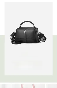 Detail of black pebbled leather pillow bag with stylish geometric pattern wide strap