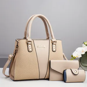 Three-piece beige tote bag set with contrasting textures and gold-toned brand hardware