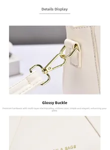 Detalle de la hebilla dorada y costuras de calidad en un bolso de cuero beige