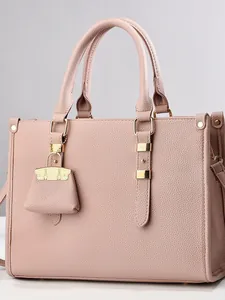 Pink lychee grain leather tote bag with gold hardware and mini charm accessory