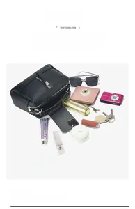 Black pebble leather commuter bag showing large capacity with daily essentials inside