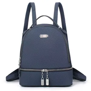 Detailed front view of navy blue backpack showing textured fabric and silver metal zippers