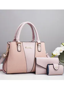 Three-piece pink leather tote bag set with matching wallet and card holder for women