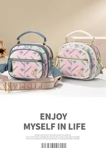 Detailed view of floral mini tote bags with adjustable wide straps and metallic logo
