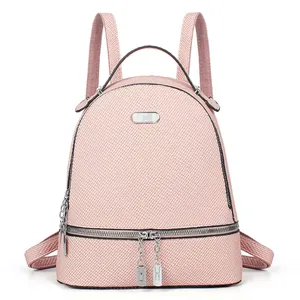 Front detail of a large light pink travel backpack with silver chain zipper and woven texture