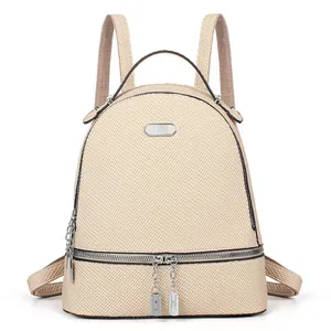 Macro view showing woven texture detail and metal zipper on this beige backpack